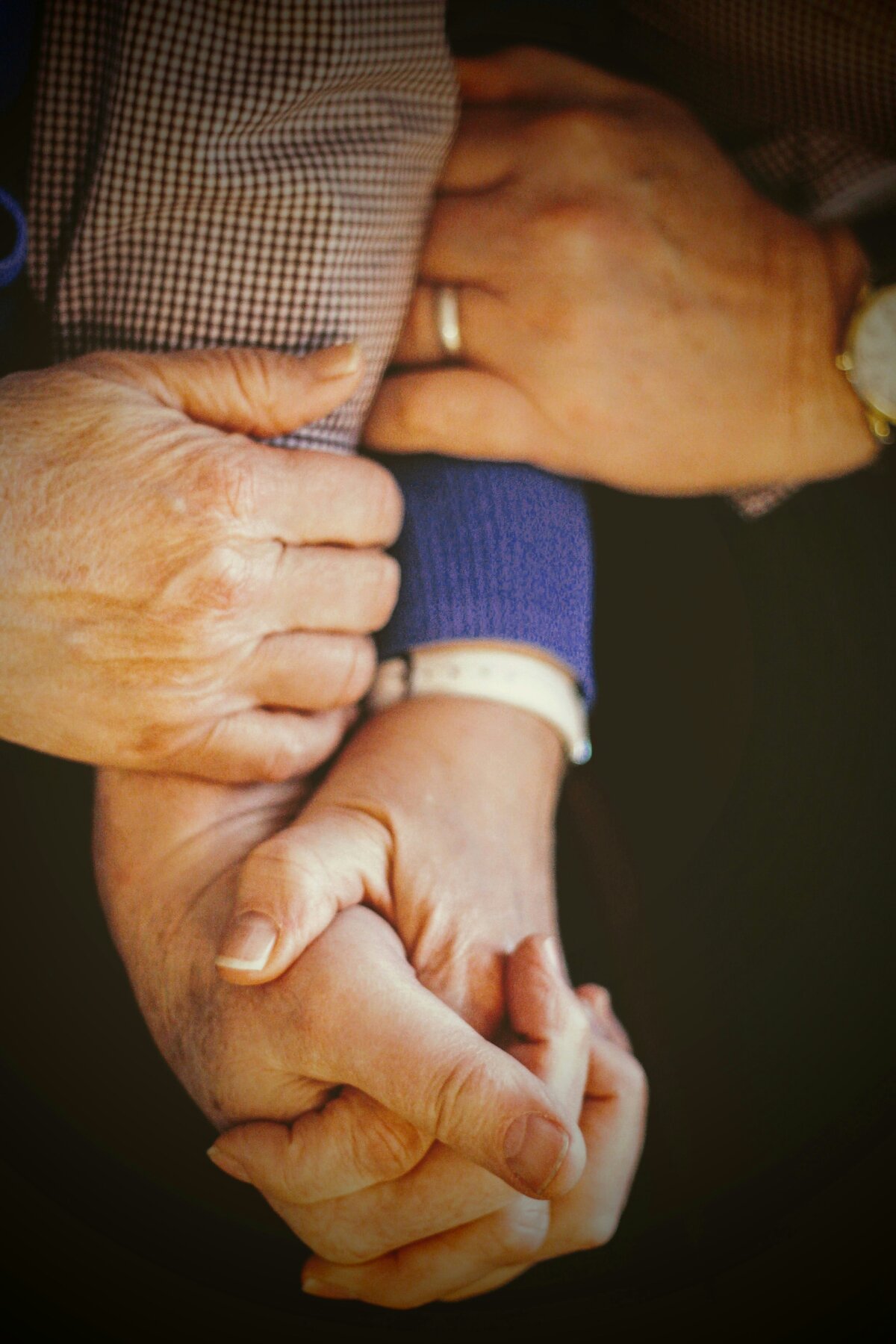 Family hands holding together showing support and care